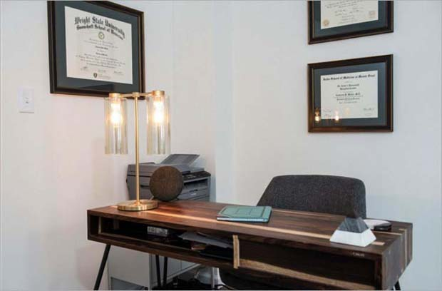 Dr. Mahle's office desk area with diplomas and modern lighting